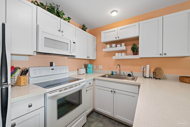 kitchen with sink, white appliances, and white cabinets