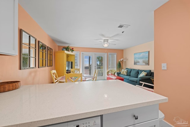 kitchen featuring white cabinetry and ceiling fan