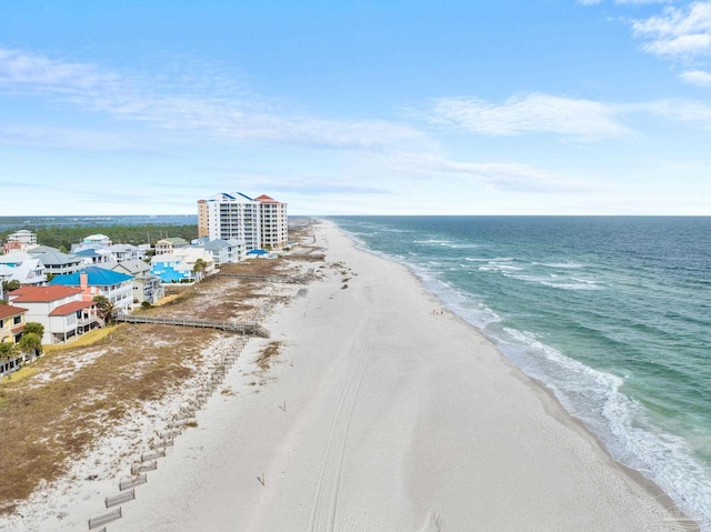 drone / aerial view featuring a water view and a beach view