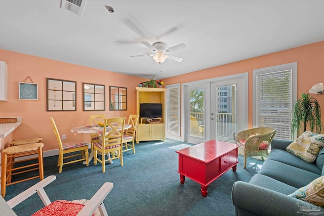 carpeted living room featuring french doors and ceiling fan