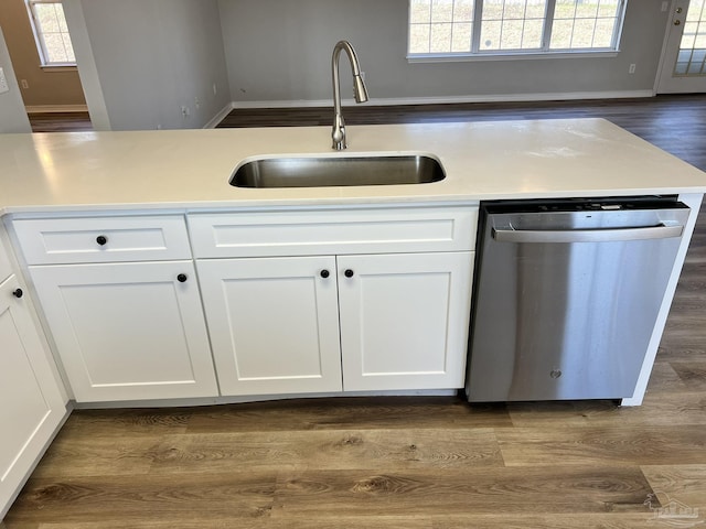 kitchen featuring white cabinetry, sink, hardwood / wood-style flooring, and dishwasher