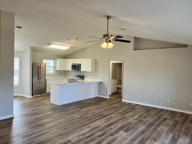 kitchen with dark hardwood / wood-style flooring, stainless steel appliances, kitchen peninsula, and white cabinets