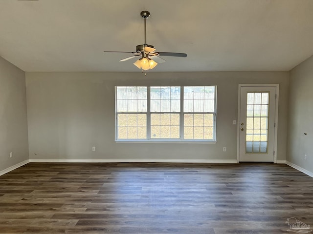 spare room featuring lofted ceiling, dark wood-type flooring, and ceiling fan