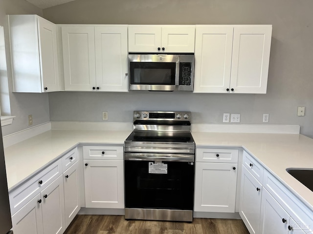 kitchen featuring white cabinetry, stainless steel appliances, and dark hardwood / wood-style floors