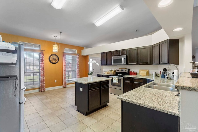 3972 Flour Mill Cir, Pace, FL 32571 - kitchen with stainless steel appliances, a sink, light tile patterned floors, dark brown cabinets, and baseboards