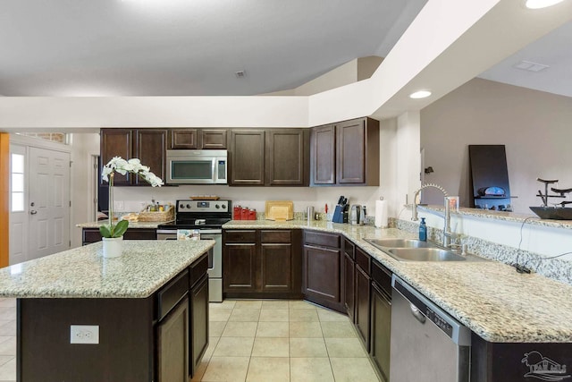 3972 Flour Mill Cir, Pace, FL 32571 - kitchen featuring appliances with stainless steel finishes, a sink, light tile patterned floors, dark brown cabinets, and recessed lighting
