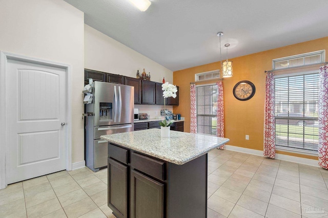 3972 Flour Mill Cir, Pace, FL 32571 - kitchen featuring stainless steel refrigerator with ice dispenser, light tile patterned floors, lofted ceiling, hanging light fixtures, and healthy amount of natural light