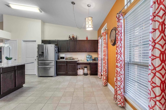 3972 Flour Mill Cir, Pace, FL 32571 - kitchen featuring stainless steel fridge with ice dispenser, plenty of natural light, dark brown cabinets, and light tile patterned floors