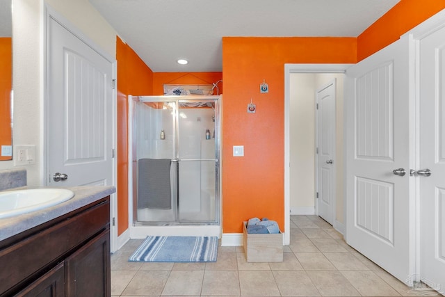 3972 Flour Mill Cir, Pace, FL 32571 - bathroom featuring a stall shower, vanity, tile patterned flooring, and baseboards