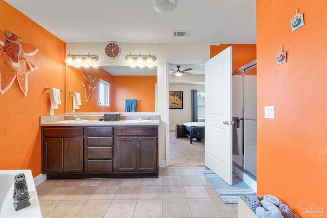 3972 Flour Mill Cir, Pace, FL 32571 - ensuite bathroom with double vanity, a shower stall, a ceiling fan, tile patterned floors, and plenty of natural light