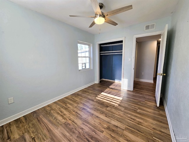 unfurnished bedroom with a closet, ceiling fan, and dark hardwood / wood-style flooring