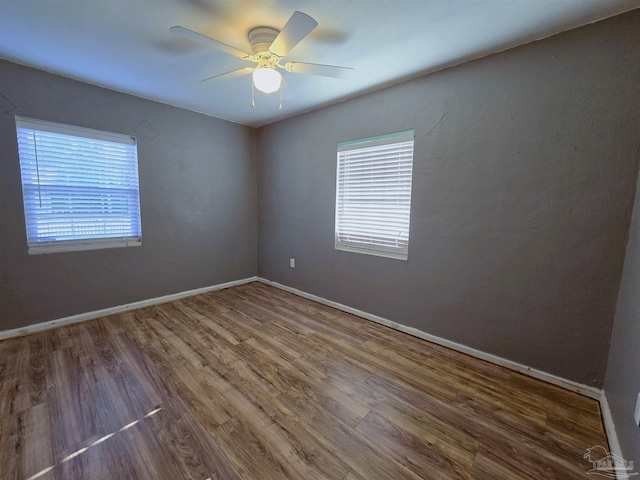 spare room featuring hardwood / wood-style flooring and ceiling fan