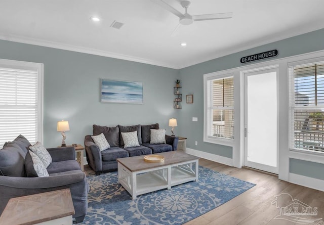 1592 W Beach Blvd Unit Kk, Gulf Shores, AL 36542 - living room featuring plenty of natural light, wood finished floors, ceiling fan, baseboards, and crown molding