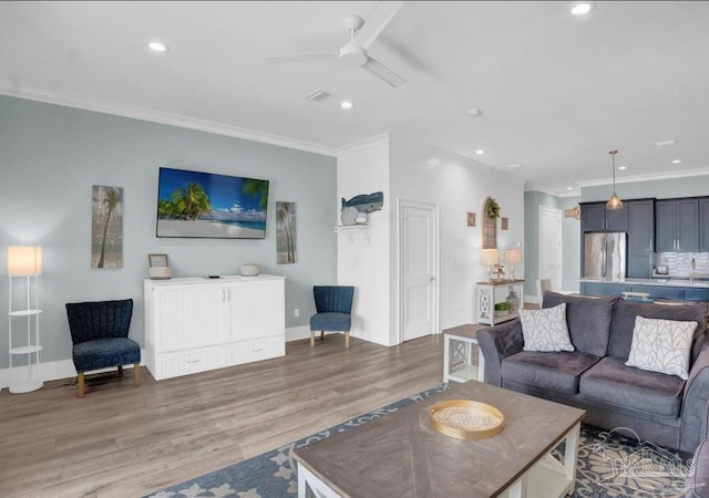 1592 W Beach Blvd Unit Kk, Gulf Shores, AL 36542 - living area featuring a ceiling fan, crown molding, recessed lighting, light wood-style floors, and baseboards