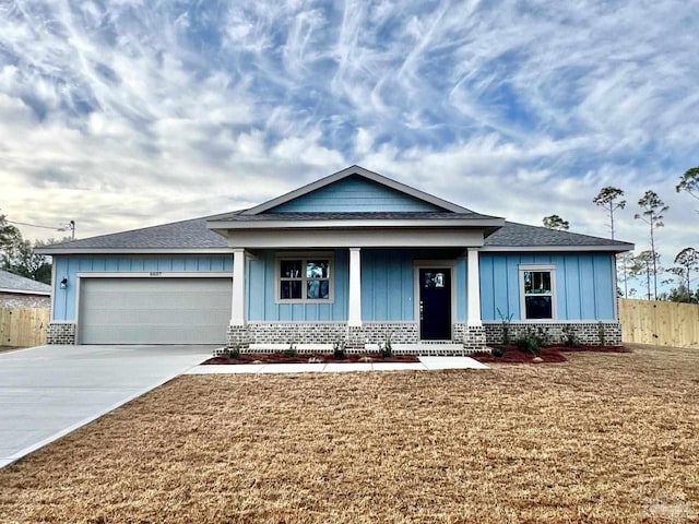 6607 Rocky Shores Rd, Milton, FL 32583 - ranch-style home with board and batten siding, a garage, concrete driveway, a porch, and a shingled roof