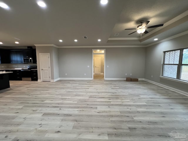 6607 Rocky Shores Rd, Milton, FL 32583 - unfurnished living room featuring crown molding, light wood finished floors, a ceiling fan, recessed lighting, and a tray ceiling