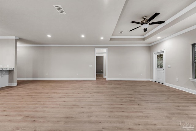6607 Rocky Shores Rd, Milton, FL 32583 - unfurnished living room featuring ornamental molding, recessed lighting, light wood-style flooring, ceiling fan, and a raised ceiling
