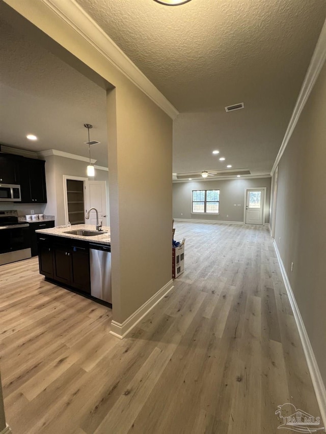 6607 Rocky Shores Rd, Milton, FL 32583 - hallway featuring crown molding, light wood finished floors, a textured ceiling, and recessed lighting