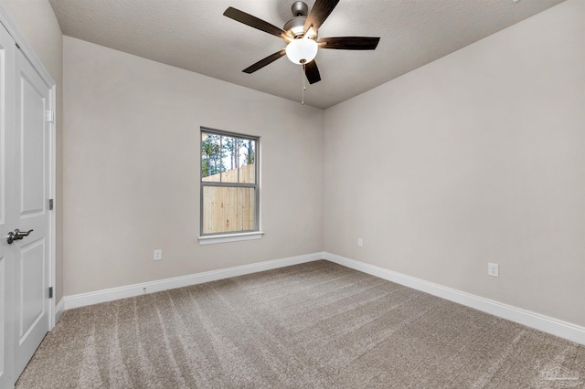 empty room featuring carpet flooring, ceiling fan, and a textured ceiling