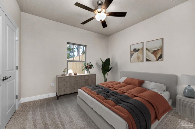 carpeted bedroom featuring a textured ceiling and ceiling fan