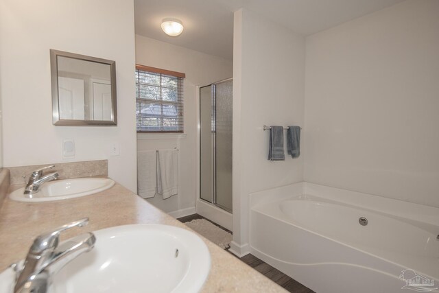 bathroom featuring vanity and shower with separate bathtub