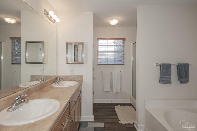 bathroom featuring hardwood / wood-style flooring, vanity, and independent shower and bath