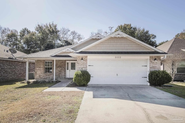 single story home featuring a garage and a front yard