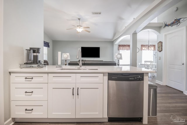 kitchen with sink, dark wood-type flooring, stainless steel dishwasher, and white cabinets