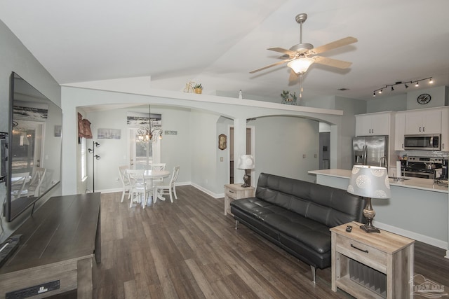 living room with sink, dark wood-type flooring, ceiling fan, and vaulted ceiling