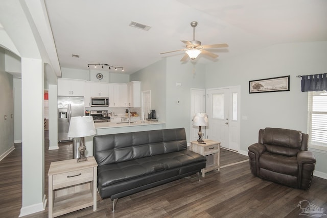 living room featuring vaulted ceiling, dark wood-type flooring, and ceiling fan