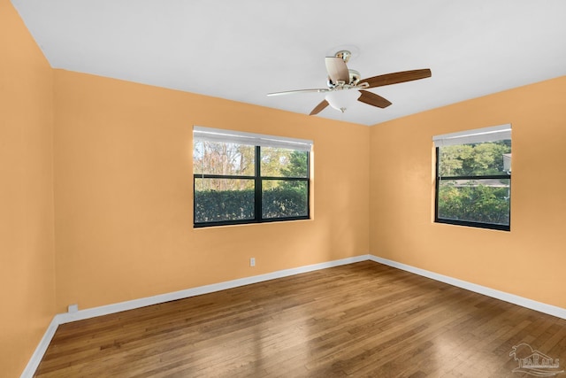 unfurnished room with hardwood / wood-style floors, ceiling fan, and a wealth of natural light