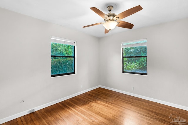 empty room featuring hardwood / wood-style floors and ceiling fan