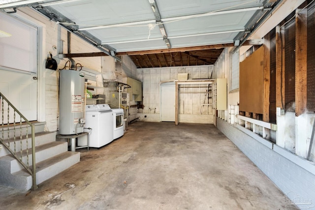 garage with washer and clothes dryer and gas water heater