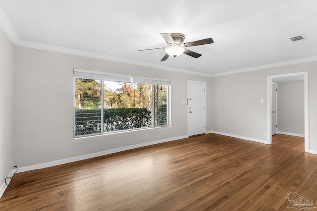 spare room featuring dark hardwood / wood-style floors, ceiling fan, and crown molding