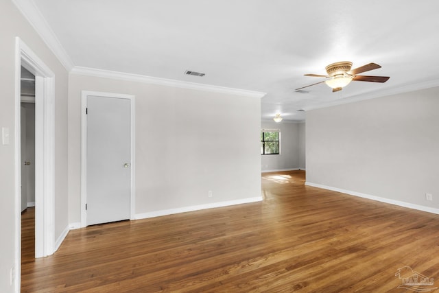 empty room featuring ceiling fan, wood-type flooring, and crown molding