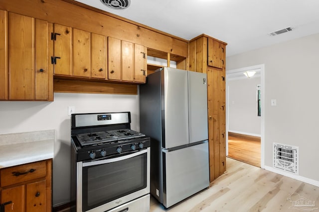 kitchen with light wood-type flooring and stainless steel appliances