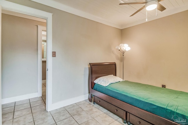 tiled bedroom with ceiling fan and ornamental molding