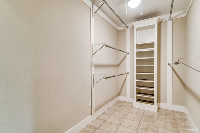 walk in closet with light tile patterned flooring