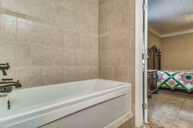 bathroom with tile patterned floors and a bath