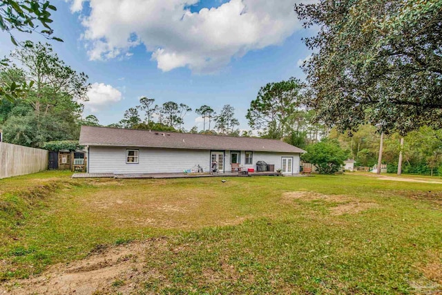 rear view of house featuring a lawn