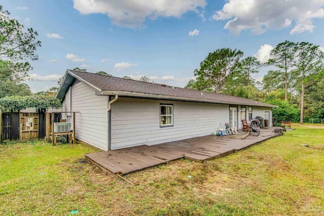 back of house featuring a deck and a yard