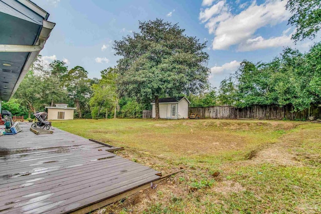 view of yard with a shed and a wooden deck