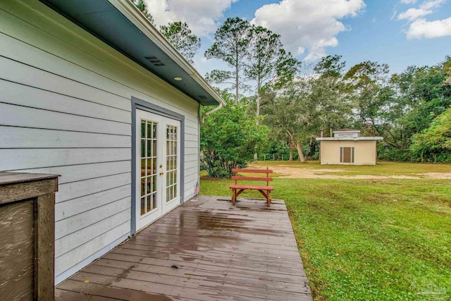 wooden terrace featuring french doors and a lawn