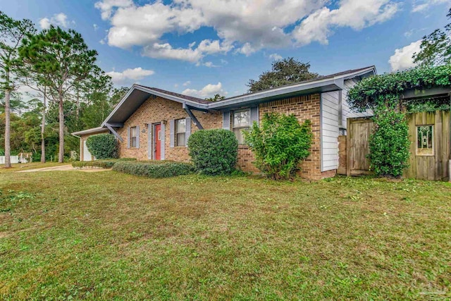 view of side of property featuring a yard