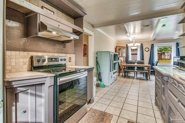 kitchen featuring backsplash, crown molding, electric range, a notable chandelier, and light tile patterned flooring