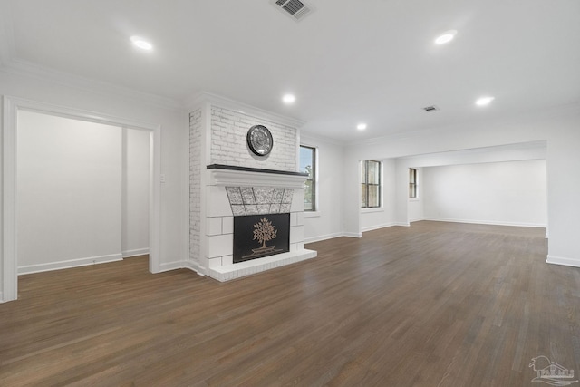 unfurnished living room with a large fireplace, dark wood-type flooring, and ornamental molding