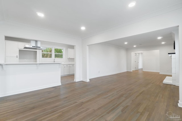 unfurnished living room featuring dark hardwood / wood-style flooring and crown molding