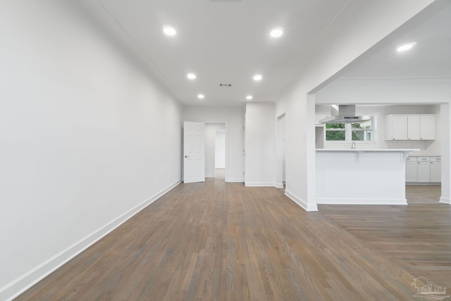 unfurnished living room with dark hardwood / wood-style floors