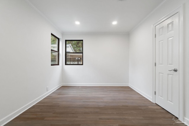 unfurnished room with ornamental molding and dark wood-type flooring