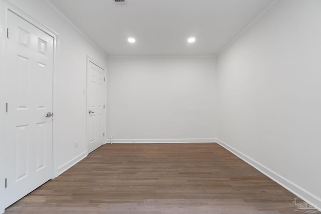 unfurnished room featuring visible vents, wood finished floors, recessed lighting, crown molding, and baseboards